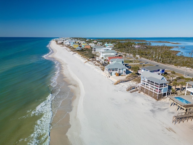 birds eye view of property with a beach view and a water view