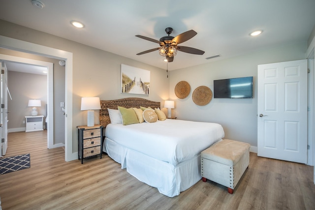 bedroom with hardwood / wood-style floors and ceiling fan