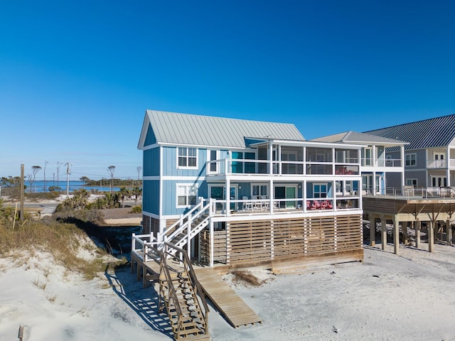 rear view of property featuring a sunroom