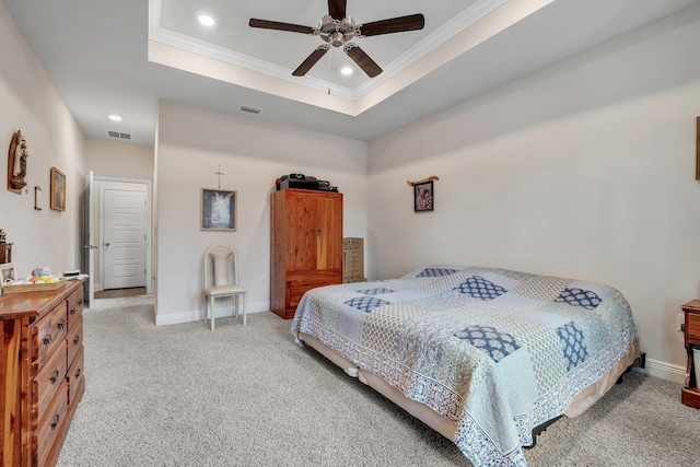 bedroom featuring light colored carpet, a raised ceiling, ceiling fan, and crown molding