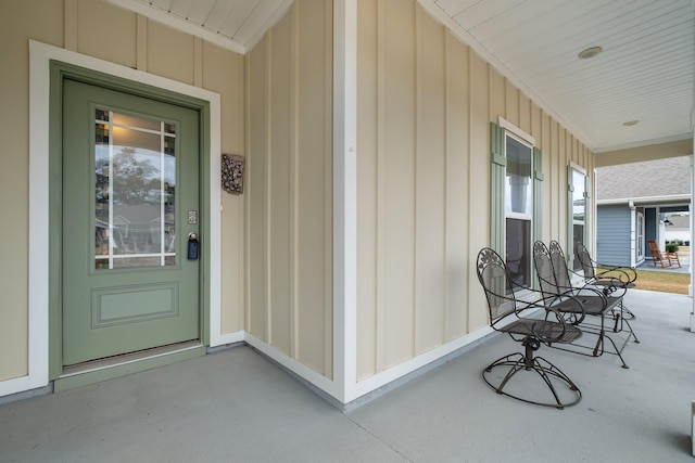 view of exterior entry with a porch