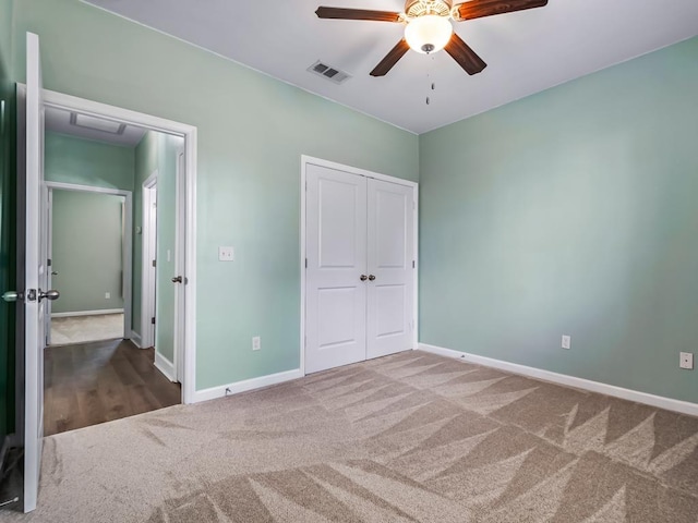 unfurnished bedroom with ceiling fan, a closet, and carpet