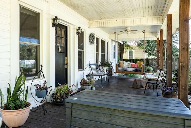 wooden deck with covered porch and ceiling fan