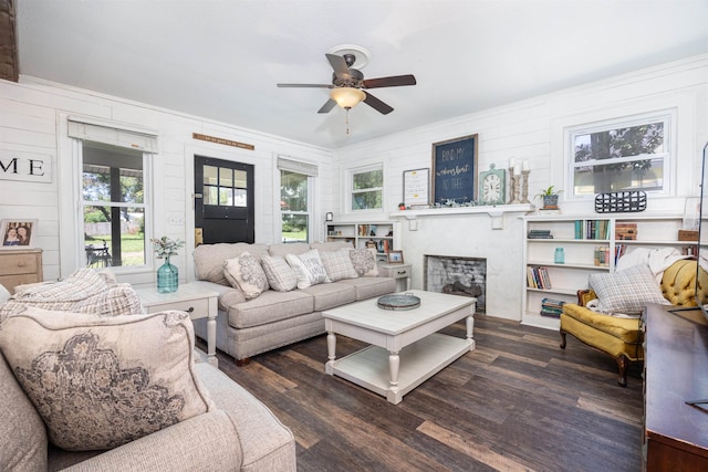 living room featuring dark hardwood / wood-style flooring and ceiling fan