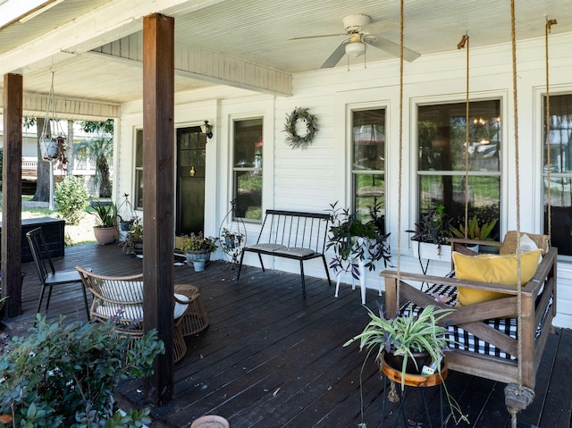 wooden terrace with ceiling fan and covered porch