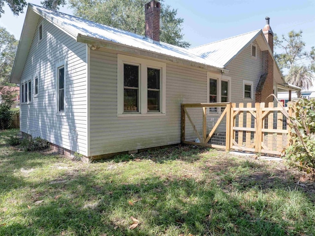 rear view of house with a lawn