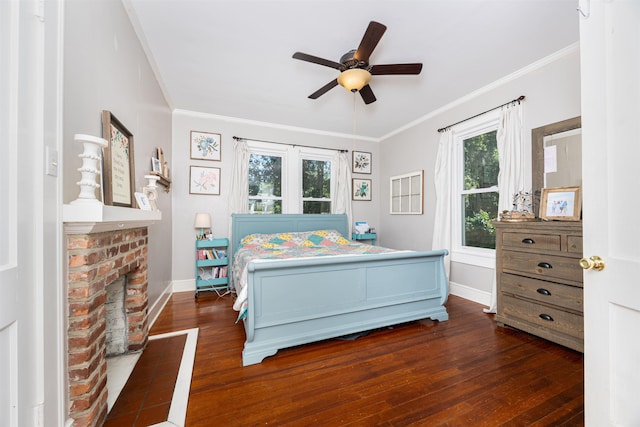 bedroom with dark hardwood / wood-style flooring, a brick fireplace, crown molding, and ceiling fan