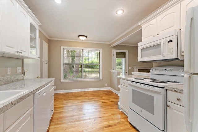 kitchen featuring white appliances, light hardwood / wood-style flooring, white cabinetry, light stone counters, and ornamental molding