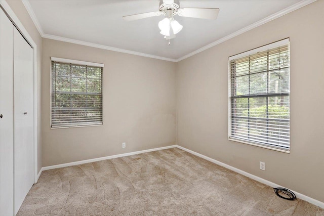 unfurnished bedroom with light carpet, ornamental molding, a closet, and ceiling fan