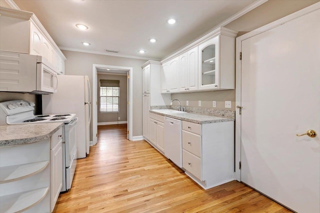 kitchen featuring white cabinetry, sink, white appliances, and light wood-type flooring