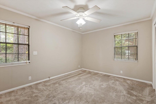 spare room with ceiling fan, light colored carpet, and ornamental molding