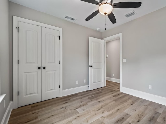 70 Beeler Rd, Crawfordville, FL 32327 - unfurnished bedroom with wood finished floors, a closet, and a ceiling fan