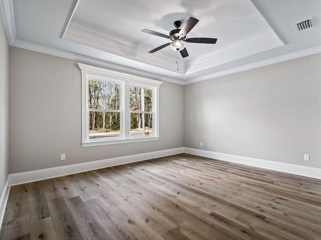 70 Beeler Rd, Crawfordville, FL 32327 - spare room with a raised ceiling, crown molding, a ceiling fan, and wood finished floors