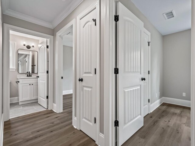 70 Beeler Rd, Crawfordville, FL 32327 - corridor with light wood-style floors and ornamental molding
