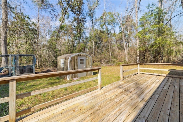 wooden terrace with a lawn and a storage shed