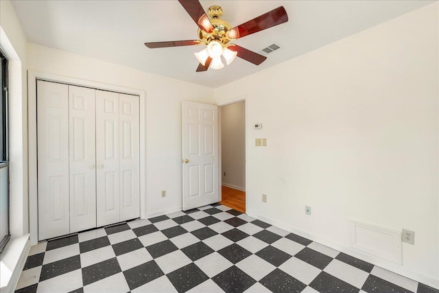 unfurnished bedroom featuring a closet and ceiling fan