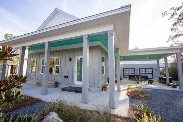 entrance to property featuring a patio area and board and batten siding