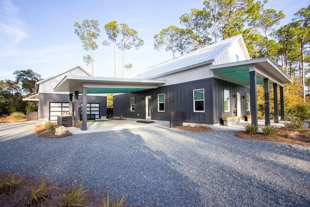 view of front of house featuring metal roof, gravel driveway, and a garage