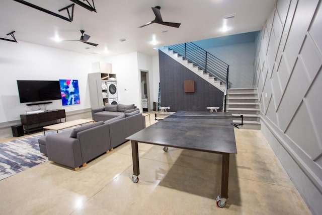 game room with finished concrete flooring and ceiling fan