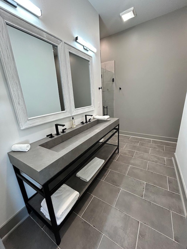 bathroom featuring a shower stall and baseboards