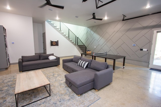 living area with stairway, baseboards, an accent wall, recessed lighting, and ceiling fan