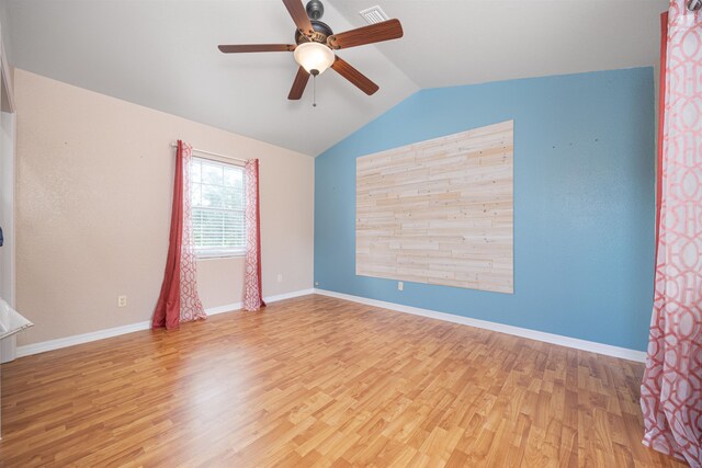 empty room with ceiling fan, light hardwood / wood-style flooring, and lofted ceiling