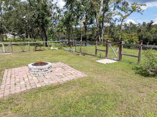 view of yard with an outdoor fire pit and a patio area