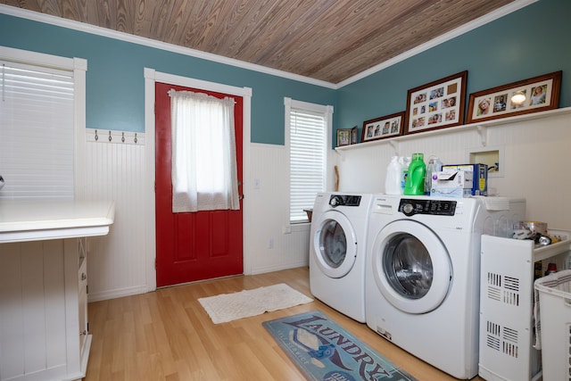 clothes washing area featuring independent washer and dryer, wooden ceiling, ornamental molding, and light hardwood / wood-style flooring