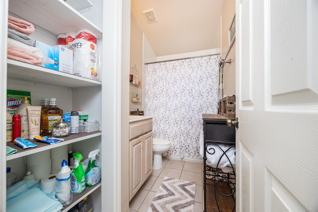 bathroom with tile patterned flooring, vanity, and toilet