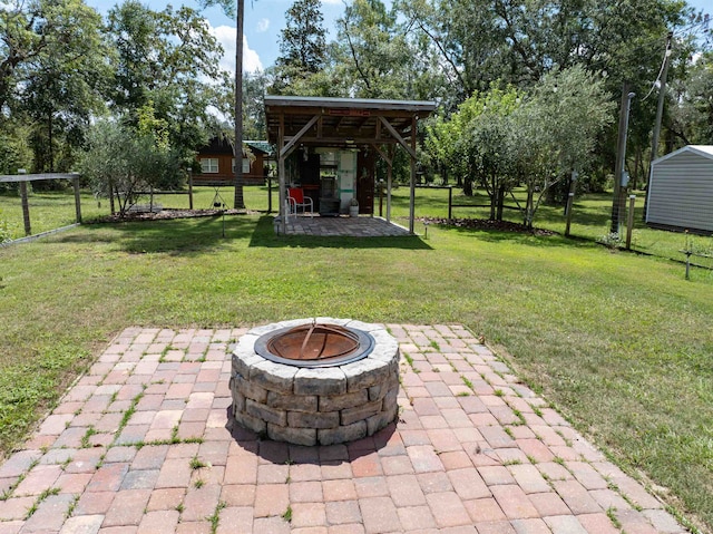 view of yard with a patio area, a fire pit, and a gazebo