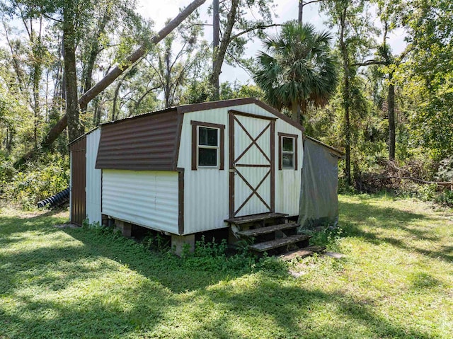 view of outbuilding with a yard