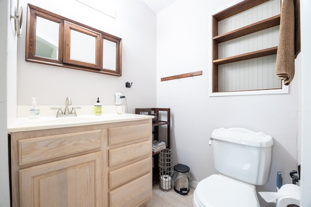 bathroom featuring toilet, vanity, and tile patterned flooring