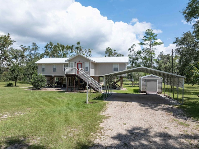 view of front of house with a front yard and a carport