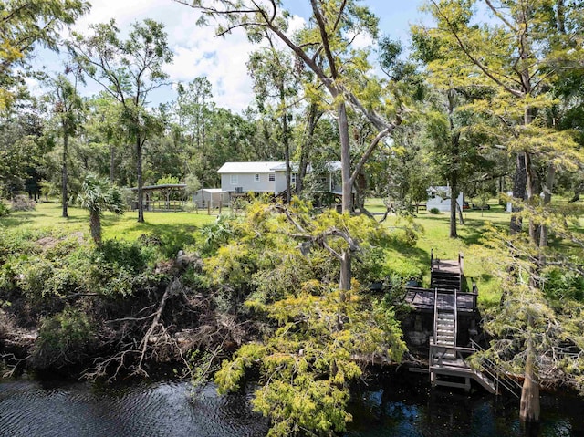 view of property's community featuring a water view and a lawn