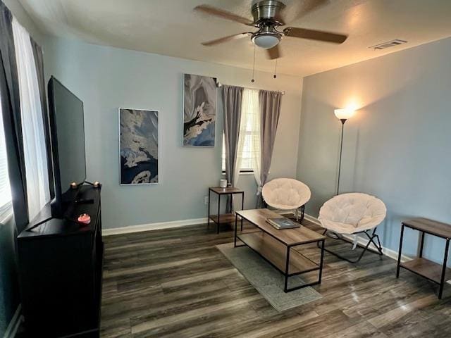 sitting room with dark hardwood / wood-style flooring and ceiling fan