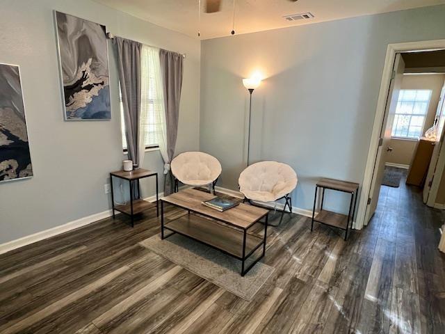 sitting room with ceiling fan and dark hardwood / wood-style floors