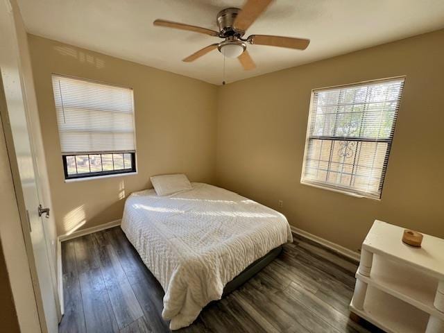 bedroom with ceiling fan and dark hardwood / wood-style floors