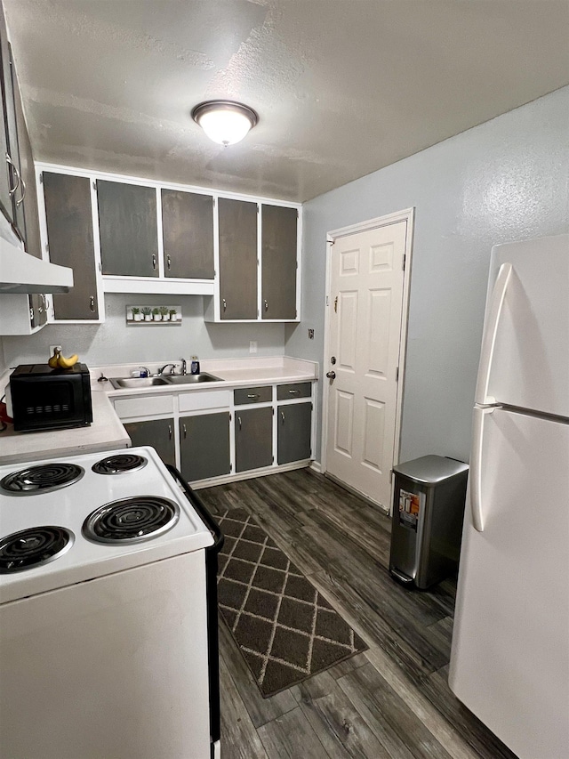 kitchen featuring sink, a textured ceiling, white appliances, dark hardwood / wood-style floors, and ventilation hood