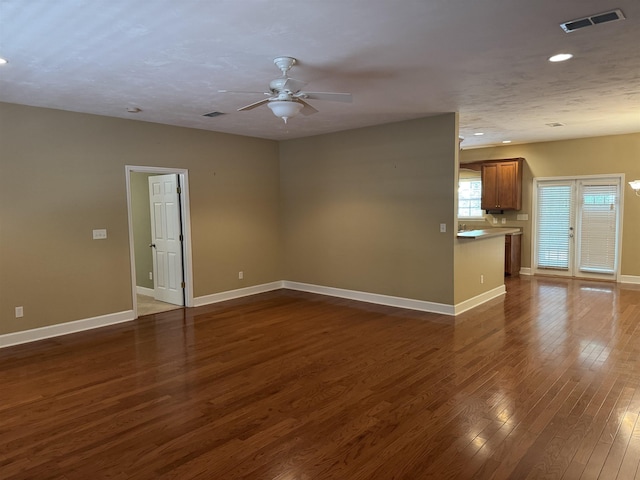 unfurnished living room with visible vents, baseboards, ceiling fan, recessed lighting, and dark wood finished floors