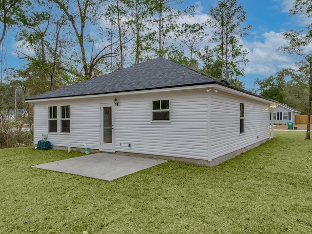 rear view of house with a lawn and a patio area