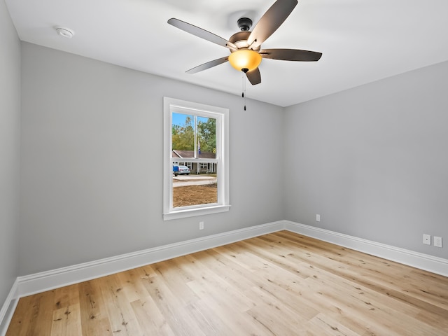 spare room with light wood-type flooring and ceiling fan