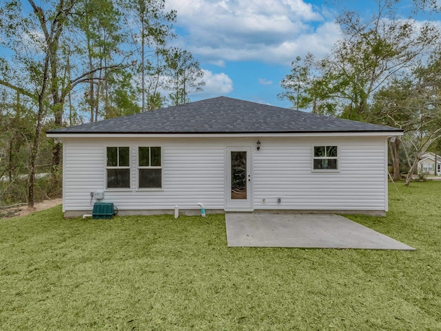 back of house with central air condition unit, a patio, and a yard