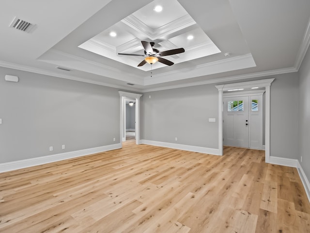 spare room featuring light hardwood / wood-style floors, a raised ceiling, ceiling fan, and crown molding