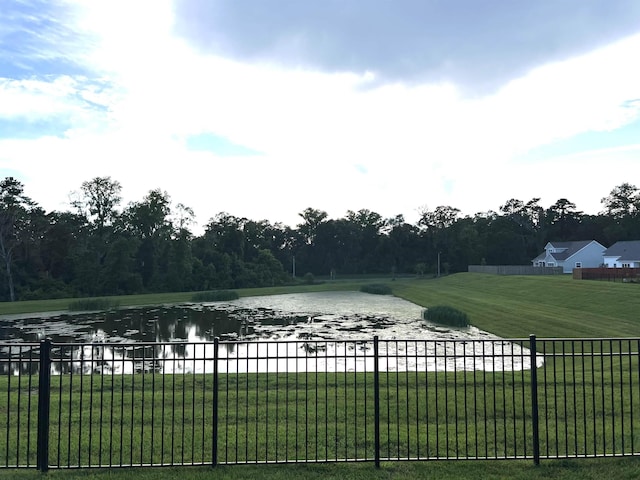 view of property's community featuring a water view and a yard