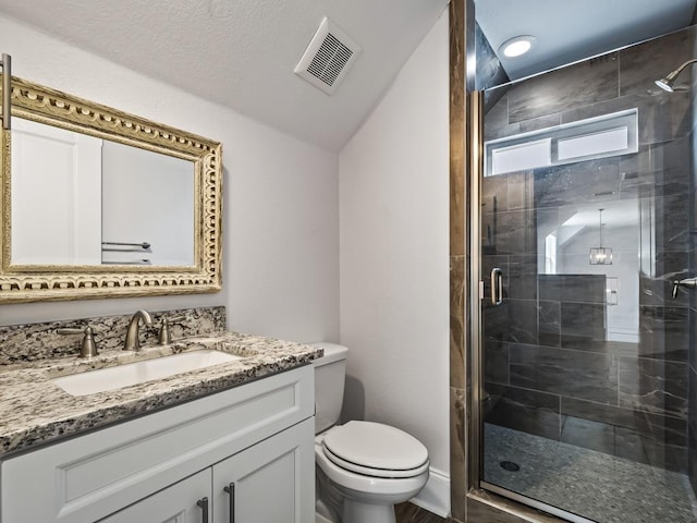 bathroom with vanity, toilet, and an enclosed shower