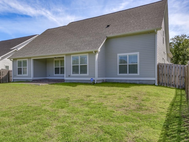 back of house with a lawn