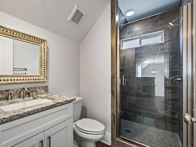 bathroom featuring vanity, toilet, and a shower with shower door