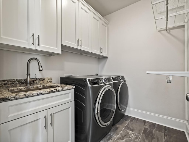 laundry room with sink, cabinets, and independent washer and dryer