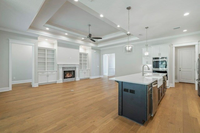 8451 Hickory Branch Trl, Tallahassee, FL 32312 - kitchen featuring appliances with stainless steel finishes, ceiling fan, light countertops, ornamental molding, and decorative light fixtures