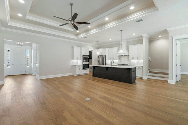 8451 Hickory Branch Trl, Tallahassee, FL 32312 - unfurnished living room featuring a ceiling fan, wood finished floors, a raised ceiling, crown molding, and recessed lighting